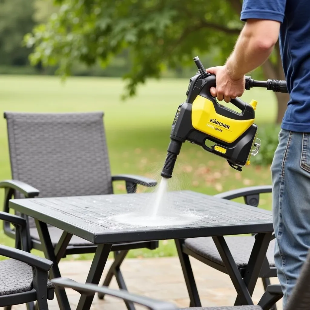 A Kärcher K5 Full Control pressure washer being used to clean outdoor patio furniture.