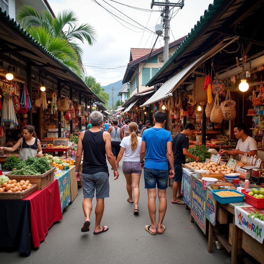 Visitors exploring a local village market near Perhentian Islands, interacting with vendors and experiencing the local culture.